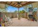 Cozy patio with rocking chairs, small table, and grill at 14525 Catalina Cir, Seminole, FL 33776