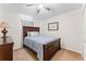 Spacious bedroom with wood furniture and ceiling fan at 14935 Skip Jack Loop # 106, Lakewood Ranch, FL 34202