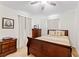 Bedroom with wood furniture, ceiling fan and beige carpet at 14935 Skip Jack Loop # 106, Lakewood Ranch, FL 34202