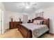 Main bedroom with wood furniture and ceiling fan at 14935 Skip Jack Loop # 106, Lakewood Ranch, FL 34202