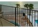 Balcony view of the beach, pool, and palm trees at 16330 Gulf Blvd # 306, Redington Beach, FL 33708