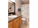 Bathroom with granite countertop and seashell shower curtain at 16330 Gulf Blvd # 306, Redington Beach, FL 33708