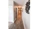 Long hallway with wood-look floors and coastal decor at 16330 Gulf Blvd # 306, Redington Beach, FL 33708