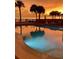 Relaxing pool area with lounge chairs at sunset at 16330 Gulf Blvd # 306, Redington Beach, FL 33708