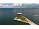 Aerial view of waterfront property with a modern building and green space at 1690 74Th N Ave, St Petersburg, FL 33702