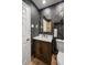 Stylish bathroom with a modern vanity, geometric wallpaper and a large mirror at 1690 74Th N Ave, St Petersburg, FL 33702