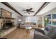 Cozy living room with a stone fireplace and sliding glass doors leading to the pool at 1690 74Th N Ave, St Petersburg, FL 33702