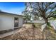 Backyard patio with fire pit and large shade tree at 1720 Hampton Ln, Clearwater, FL 33756