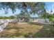 Home's backyard with large tree and white fence at 1720 Hampton Ln, Clearwater, FL 33756