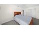 Well-lit bedroom with a double bed and carpet flooring at 1720 Hampton Ln, Clearwater, FL 33756