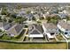 Aerial view of house with solar panels and fenced backyard at 18398 Aylesbury Ln, Land O Lakes, FL 34638