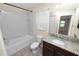 Bathroom boasts granite vanity, tub and toilet at 18398 Aylesbury Ln, Land O Lakes, FL 34638