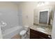 Bathroom with granite countertop vanity and bathtub at 18398 Aylesbury Ln, Land O Lakes, FL 34638