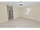 Bright bedroom with tile floors, neutral walls, and a window at 18398 Aylesbury Ln, Land O Lakes, FL 34638