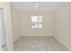 Well-lit bedroom featuring tile floors and a window at 18398 Aylesbury Ln, Land O Lakes, FL 34638