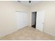 Bright bedroom with tile flooring and double door closet at 18398 Aylesbury Ln, Land O Lakes, FL 34638