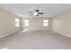 Spacious bonus room with carpet, ceiling fan and windows at 18398 Aylesbury Ln, Land O Lakes, FL 34638