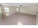 Spacious bonus room with carpet and dual windows at 18398 Aylesbury Ln, Land O Lakes, FL 34638