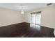 Dining room with hardwood floors, chandelier, and sliding doors to patio at 18398 Aylesbury Ln, Land O Lakes, FL 34638