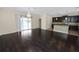 Open dining room with hardwood floors and kitchen view at 18398 Aylesbury Ln, Land O Lakes, FL 34638