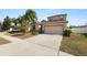 Two-story house with attached garage and driveway, parked car visible at 18398 Aylesbury Ln, Land O Lakes, FL 34638