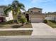 Two-story house with attached garage, palm trees, and driveway at 18398 Aylesbury Ln, Land O Lakes, FL 34638