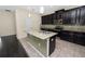 Modern kitchen with dark cabinets, granite countertop and island at 18398 Aylesbury Ln, Land O Lakes, FL 34638