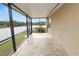 Covered patio with travertine tile flooring at 18398 Aylesbury Ln, Land O Lakes, FL 34638