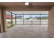 Large screened patio with tile flooring and backyard view at 18398 Aylesbury Ln, Land O Lakes, FL 34638