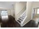 Elegant staircase with white railings in a dark hardwood floor home at 18398 Aylesbury Ln, Land O Lakes, FL 34638