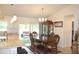 Elegant dining room with a classic wood table set, complemented by stylish chairs and a glass display cabinet at 2098 Zellwood Ter, North Port, FL 34286