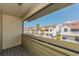 Screened balcony with a view of townhomes, mature palm trees and blue skies at 2372 Hanover Dr, Dunedin, FL 34698