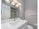 Well-lit bathroom with a large mirror, modern vanity, and sleek hardware and fixtures at 2372 Hanover Dr, Dunedin, FL 34698