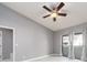 Bedroom with a ceiling fan, balcony, and light gray walls at 2372 Hanover Dr, Dunedin, FL 34698