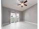 Bright bedroom with hardwood floors, a ceiling fan, and large windows providing lots of natural light at 2372 Hanover Dr, Dunedin, FL 34698