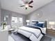 Stylishly furnished bedroom with neutral gray walls, ceiling fan, and a window with bright natural light at 2372 Hanover Dr, Dunedin, FL 34698