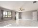 Bright bedroom with marble floors, ceiling fan, and sliding doors to the exterior at 2372 Hanover Dr, Dunedin, FL 34698