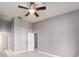 Bedroom with white floors, neutral walls, ceiling fan, and access to both a closet and bathroom at 2372 Hanover Dr, Dunedin, FL 34698