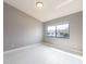 Bedroom with neutral walls and white floors showcasing ample sunlight and cozy space at 2372 Hanover Dr, Dunedin, FL 34698