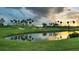 Peaceful golf course with water feature at sunset at 2372 Hanover Dr, Dunedin, FL 34698