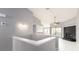 Hallway view into living room with fireplace and a view to a modern kitchen at 2372 Hanover Dr, Dunedin, FL 34698