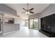 Open concept living area featuring a kitchen bar, fireplace, and sliding glass doors to a balcony at 2372 Hanover Dr, Dunedin, FL 34698