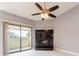 Bright living room features a dark granite fireplace and sliding doors with a balcony view at 2372 Hanover Dr, Dunedin, FL 34698