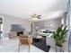 Bright living room featuring sleek marble floors, modern decor, and a stylish ceiling fan at 2372 Hanover Dr, Dunedin, FL 34698