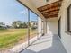 A lovely patio featuring an exposed-beam ceiling and a serene view of the surrounding lawn at 2372 Hanover Dr, Dunedin, FL 34698