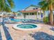 Enjoy a refreshing swim in the pool or relax in the adjacent hot tub, surrounded by lush greenery at 2372 Hanover Dr, Dunedin, FL 34698