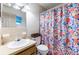 Clean bathroom with floral shower curtain and updated vanity at 27103 Wakefield Dr, Brooksville, FL 34602