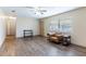 Living room featuring hardwood floors, a ceiling fan, and comfy seating at 27103 Wakefield Dr, Brooksville, FL 34602