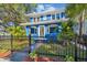 Charming blue house with a white trim, black fence, and landscaped yard at 2751 2Nd S Ave, St Petersburg, FL 33712