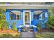 Front porch with yellow door, blue walls, and arched entryways at 2751 2Nd S Ave, St Petersburg, FL 33712